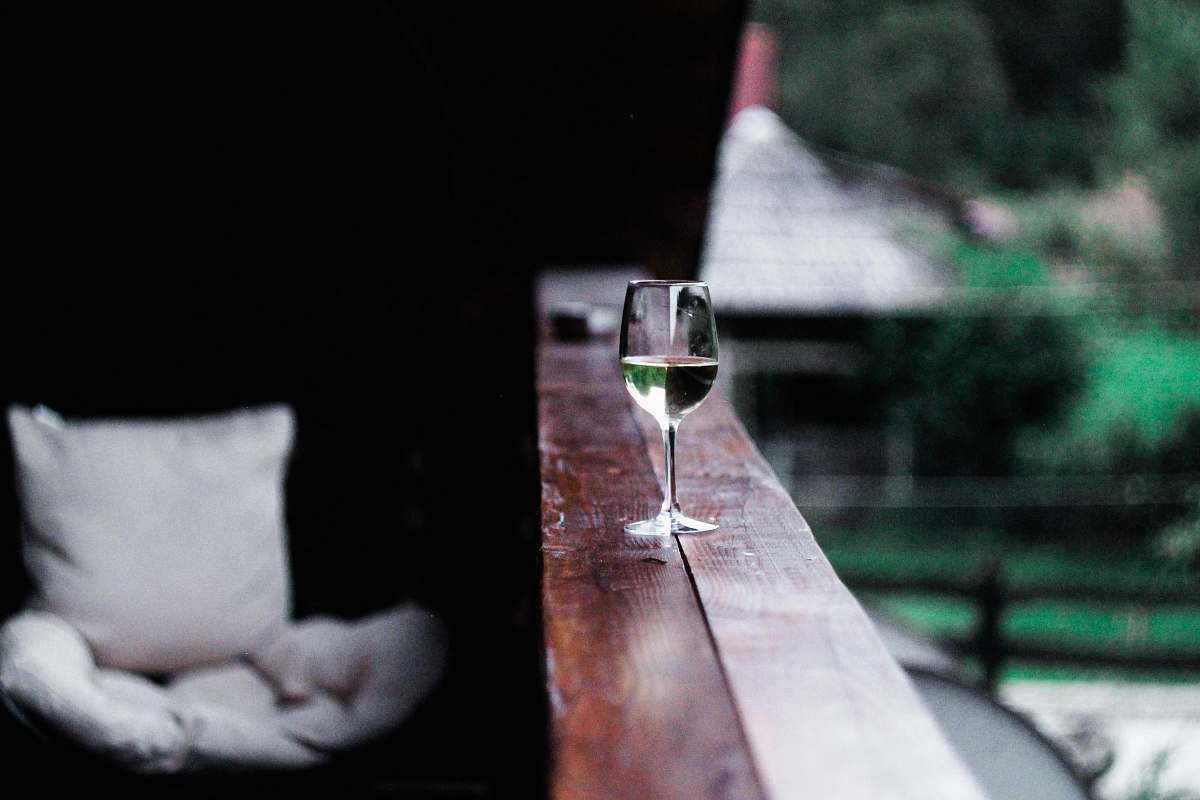 bio valeputna wine glass on wooden terrace rail valea putnei